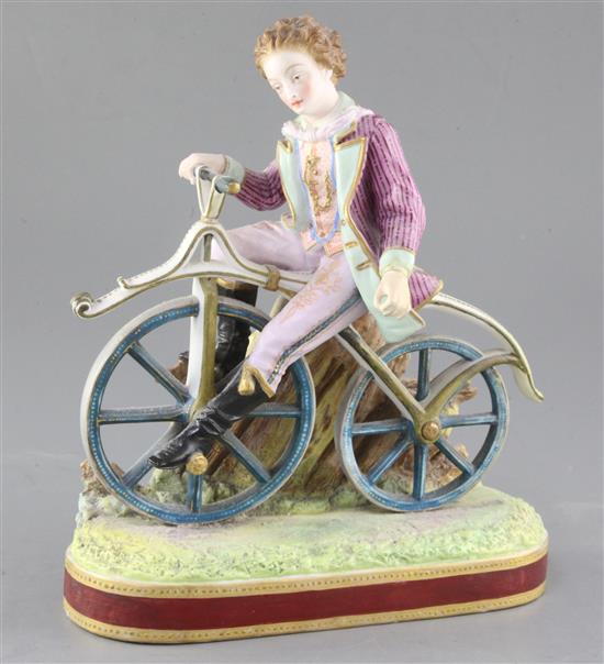 Early cycling interest: A French painted biscuit porcelain figure of a young man riding a bone shaker velocipede, height 24.5cm